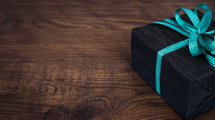 black gift box on wooden surface