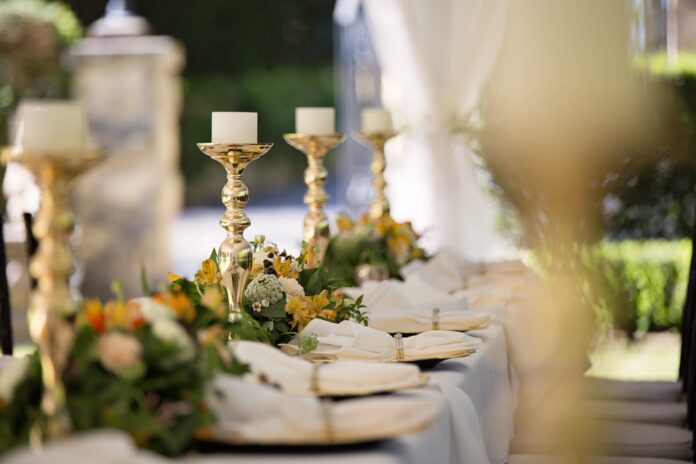 selective focus of candlesticks on table with wedding set up