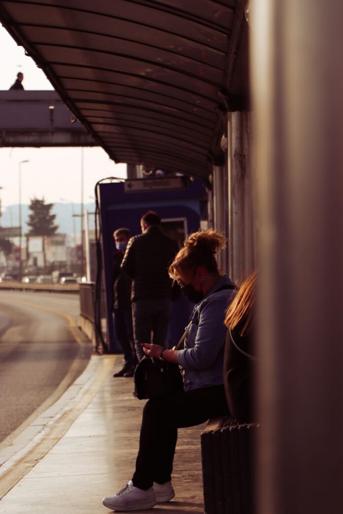 woman waiting at a bus stop