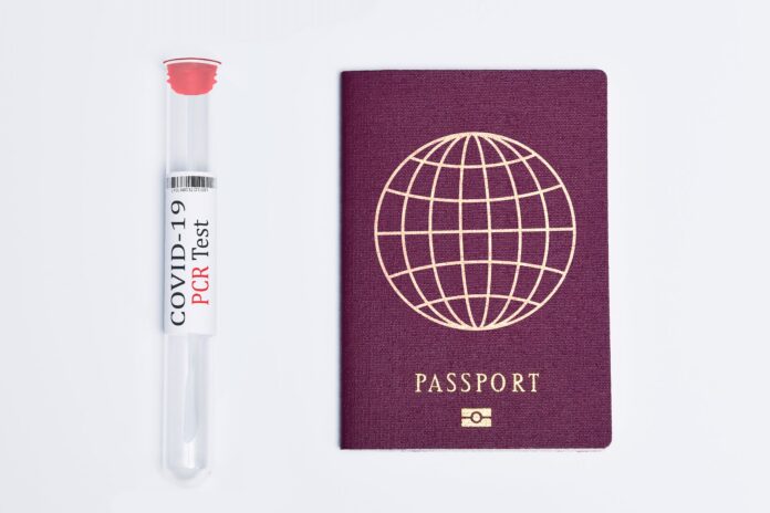 passport beside a covid test