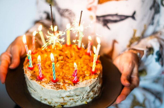 birthday cake on plate in hands
