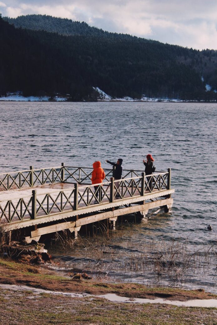 serene lake view with people on wooden pier
