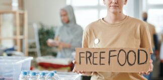 푸드뱅크를 살리기 위해 교회에 모인 로터리 클럽 회원들 a woman holding a cardboard with inscription